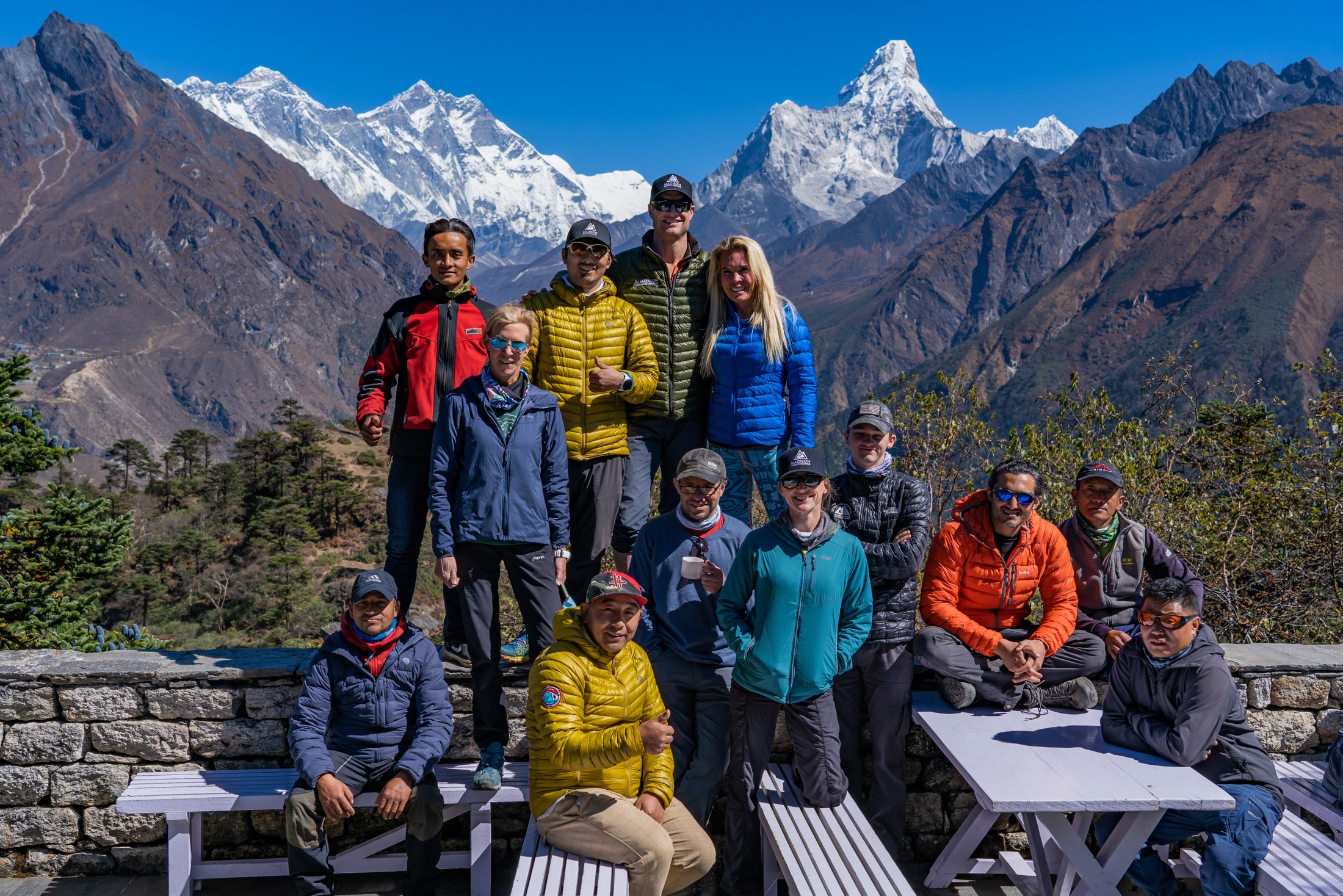 An expedition group together on a mountain trail