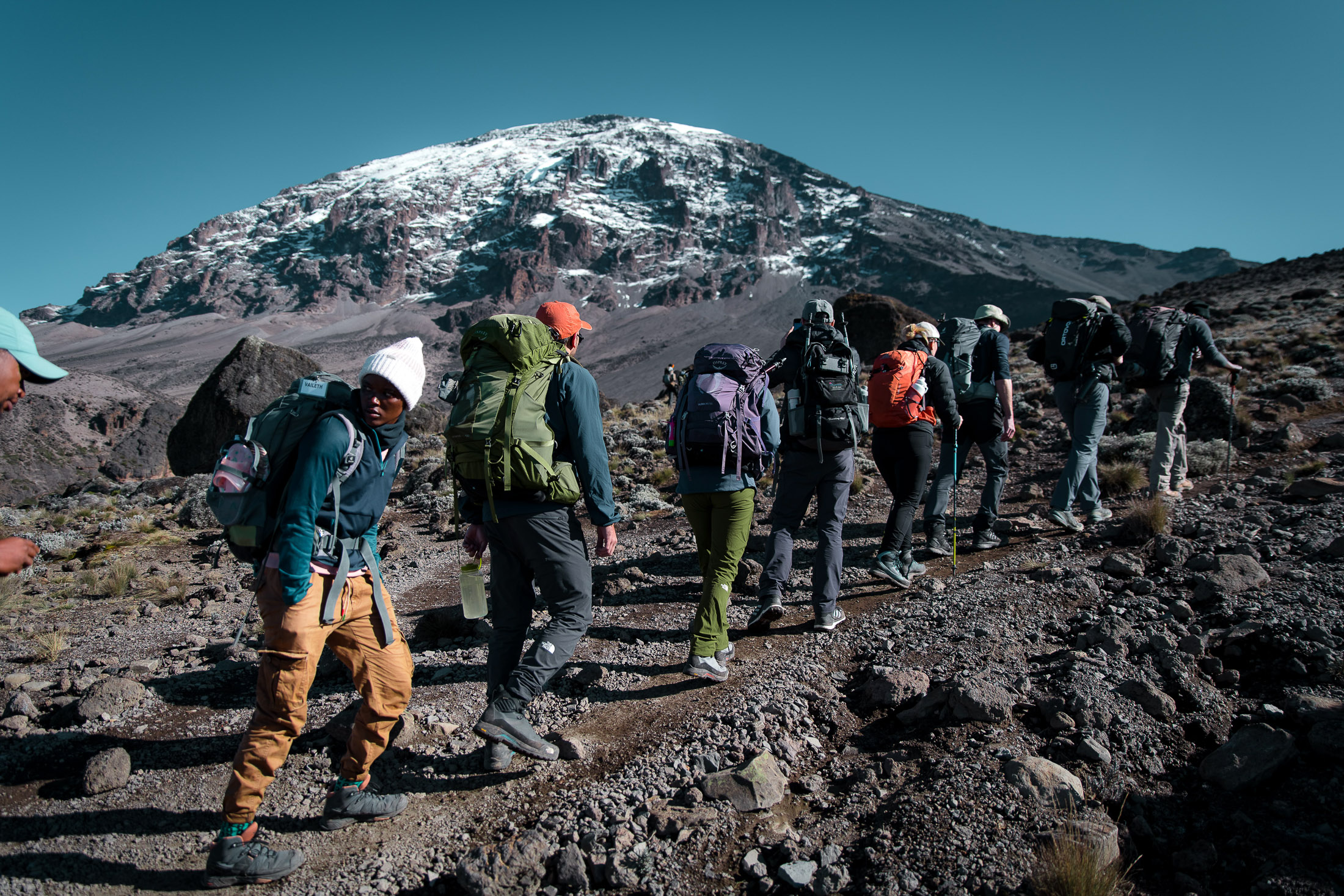 Moe on the trail to the summit of Kilimanjaro, the peak behind him