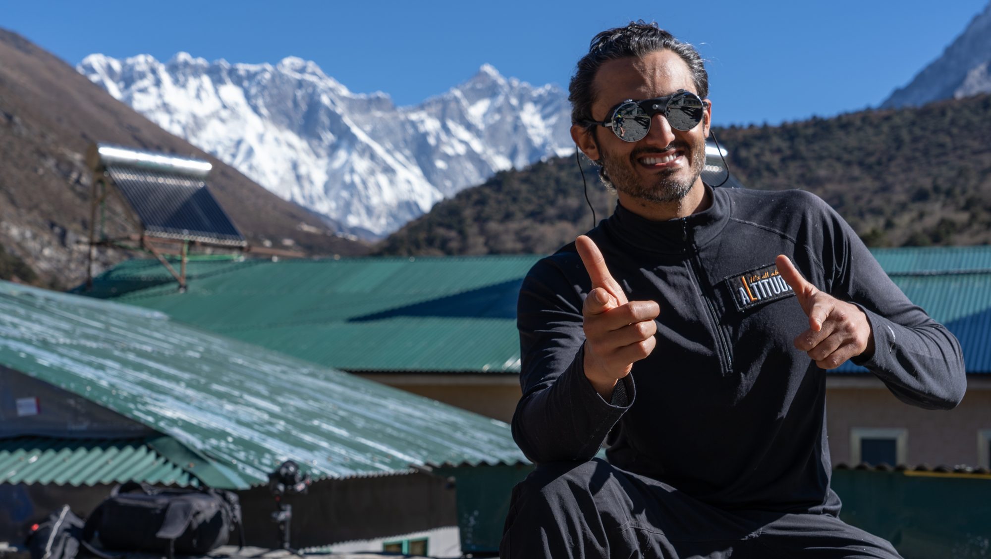 Moe smiling with Himalayan peaks behind him