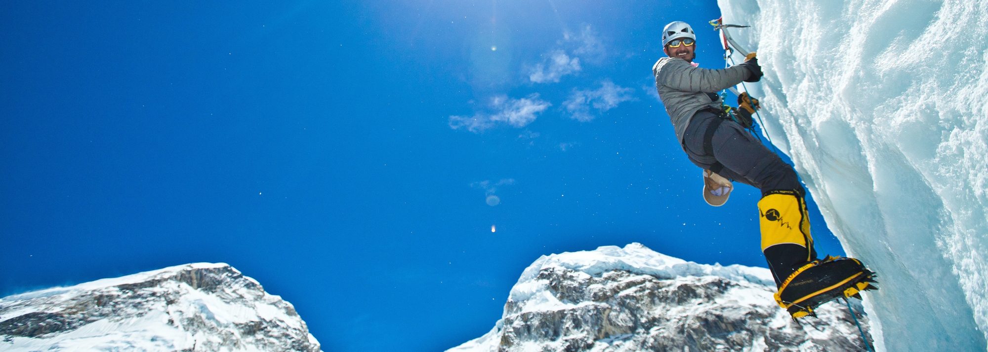 A climber scaling blue ice
