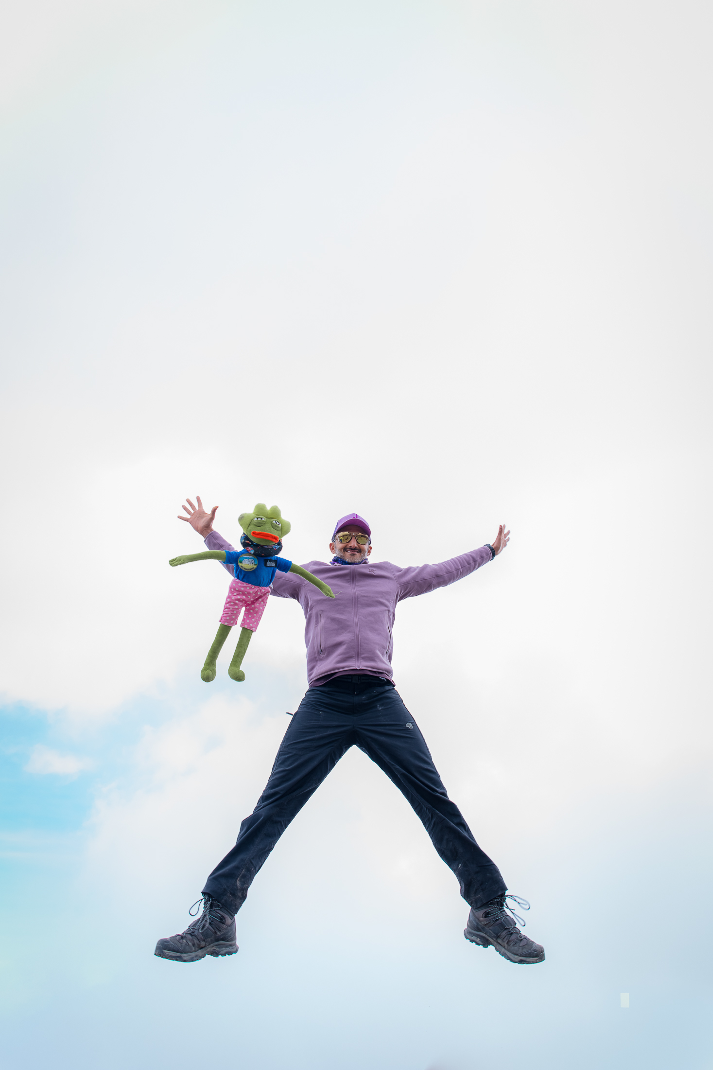 Moe jumping for joy with a young climber above the clouds